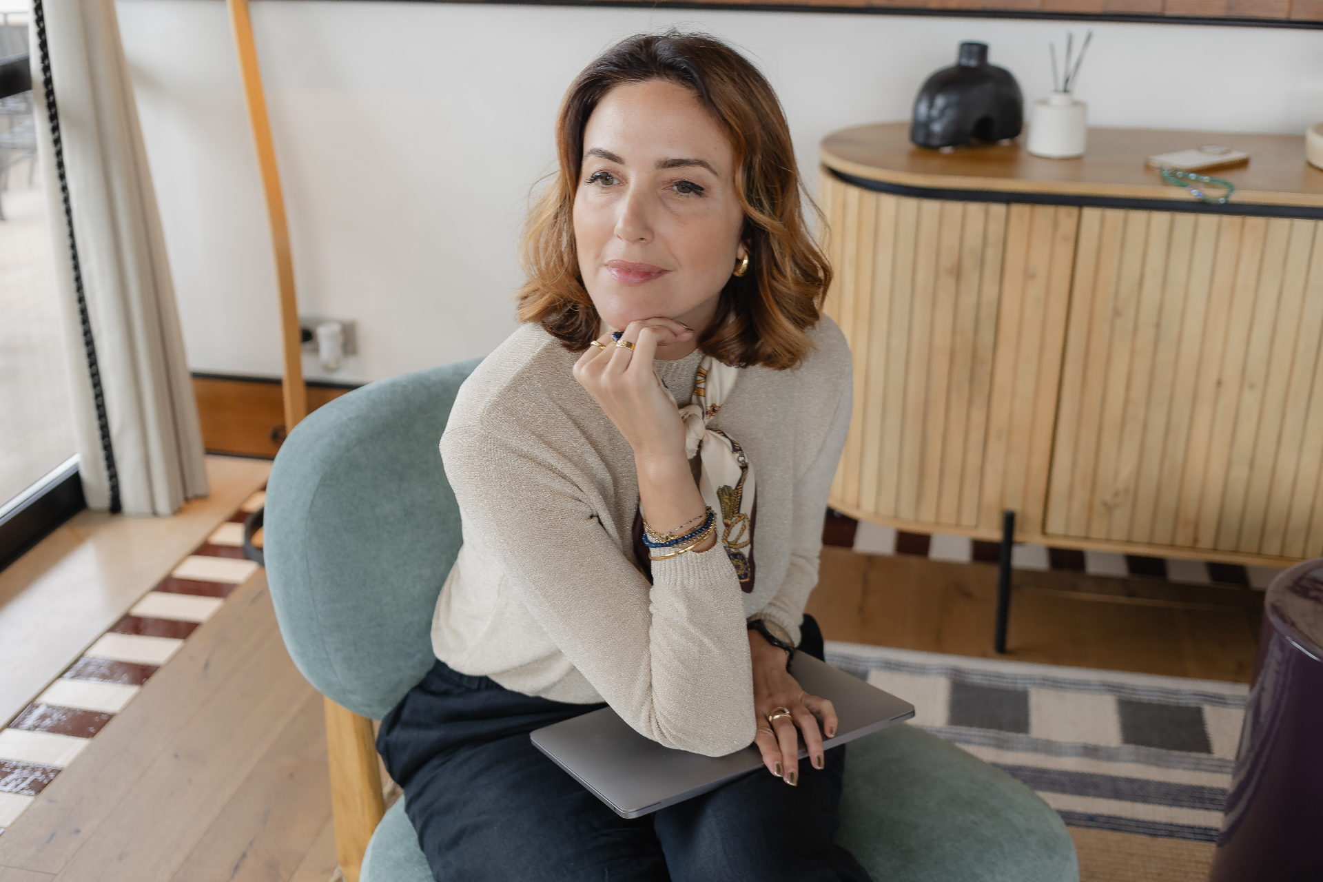 Susanna Kenyon-Muir, portfolio career coach, seated with laptop